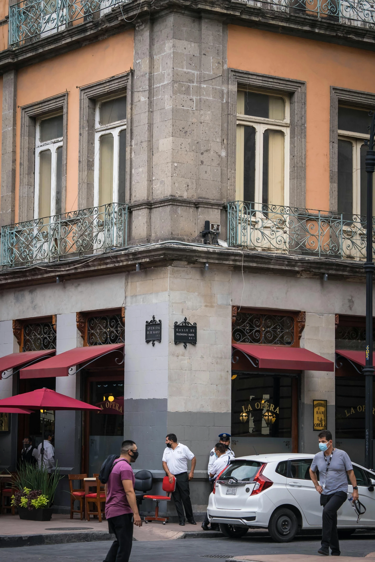 a group of people riding skateboards down a street, by Hirosada II, art nouveau, restaurant exterior photography, thumbnail, awnings, on a great neoclassical square