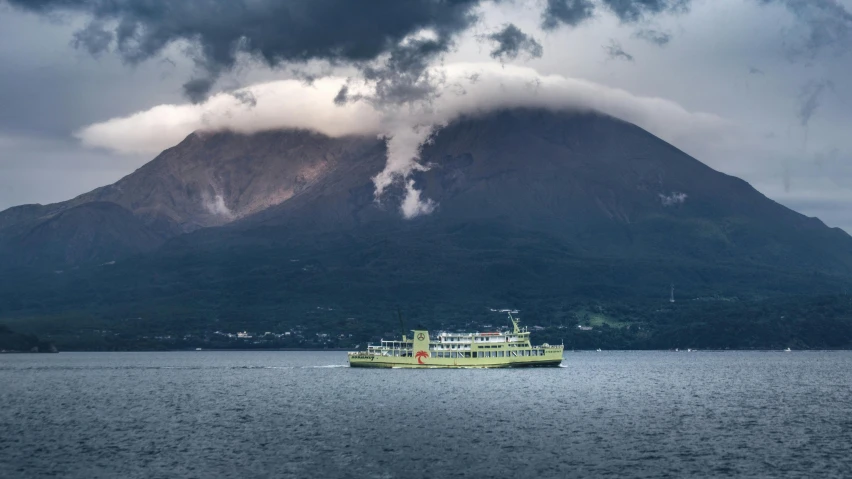 a boat in a body of water with a mountain in the background, by Yasushi Sugiyama, pexels contest winner, stormclouds, laputa, green sea, in a volcano