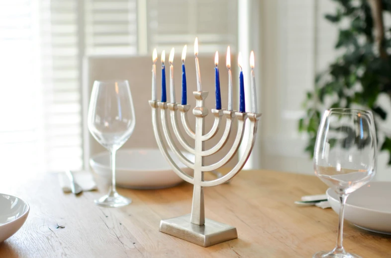 a menorah sitting on top of a wooden table, indigo, featuring rhodium wires, table light, oscar winning