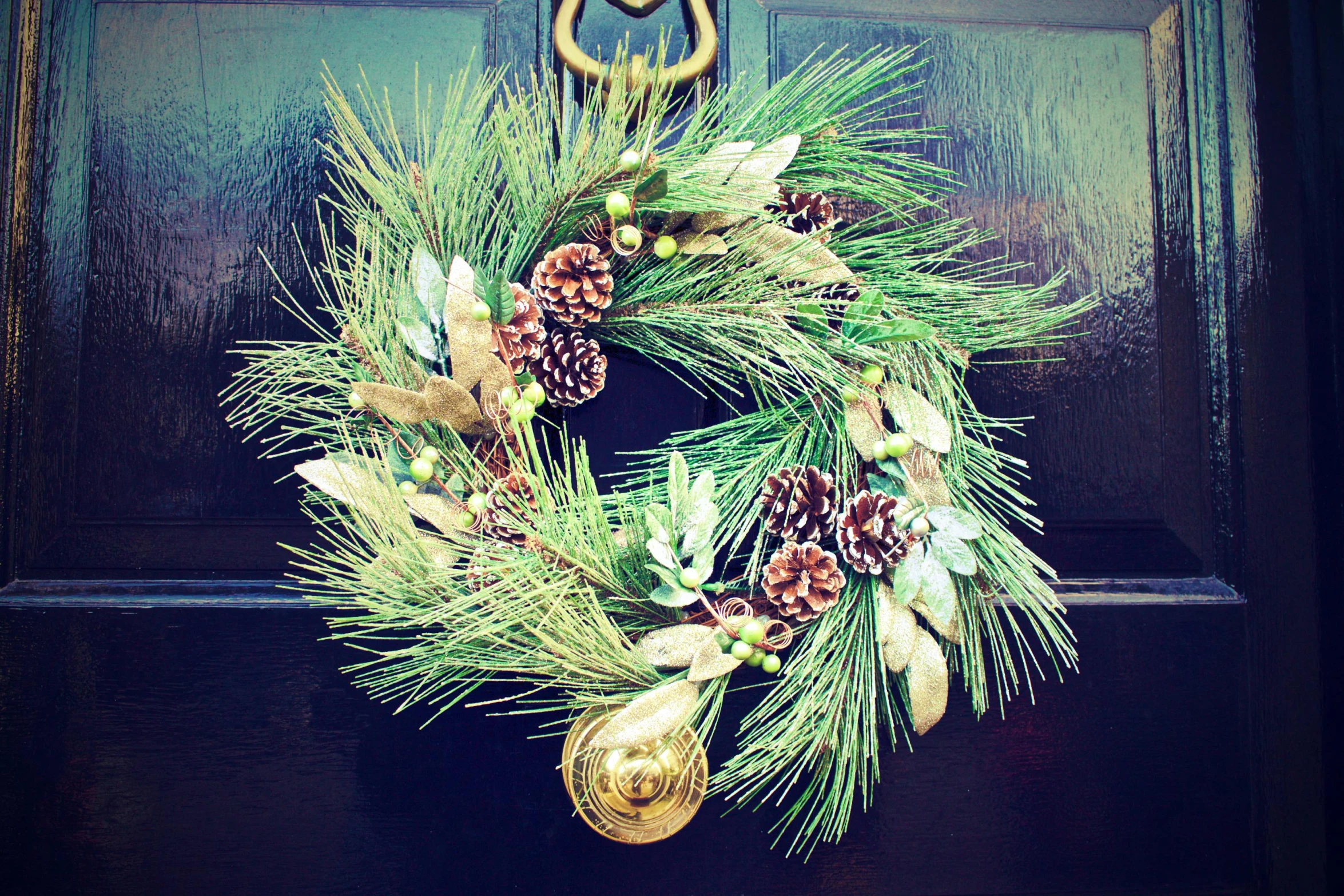 a close up of a wreath on a door, inspired by Ernest William Christmas, pexels, gold and green, square, maritime pine, bells