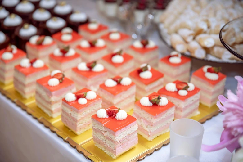 a table topped with lots of different types of desserts, a picture, square, high quality image, coral red, event photography