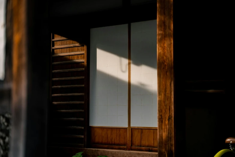 a bicycle parked in front of a wooden door, inspired by Goyō Hashiguchi, unsplash, shin hanga, contre jour, high-end onsen, ignant, photo of a beautiful window