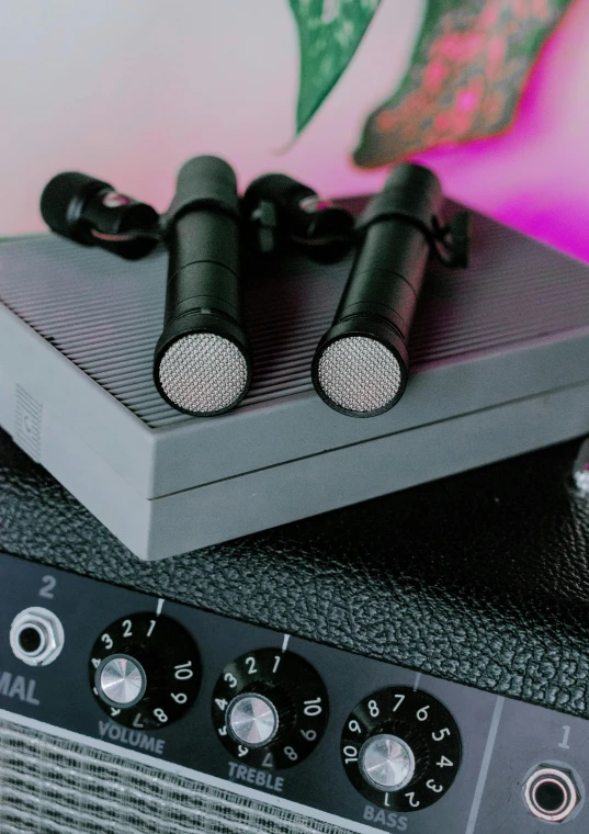 a bunch of microphones sitting on top of a amplifier, an album cover, unsplash, detailed product image, bottom - view, pair of keycards on table, high quality product image”