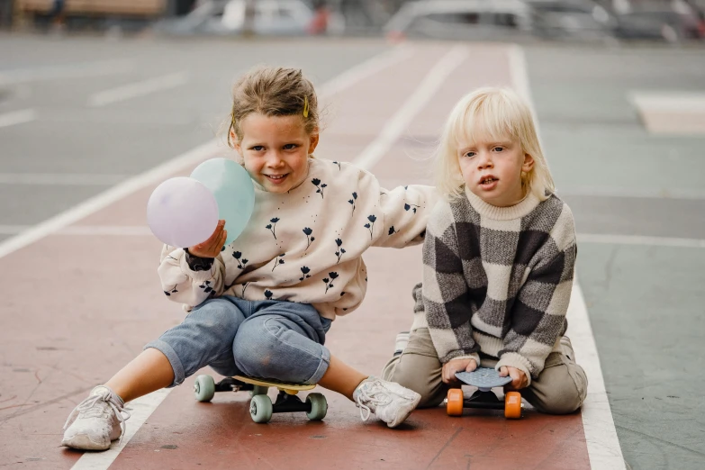 a couple of kids sitting on top of a skateboard, pexels contest winner, playmates toys, school courtyard, lena oxton, 1 4 9 3