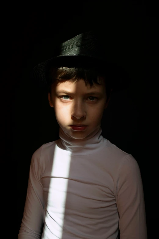 a young boy wearing a black hat and white shirt, inspired by Gottfried Helnwein, pexels contest winner, surrealism, light stubble, ignant, sunbeam, slender boy with a pale