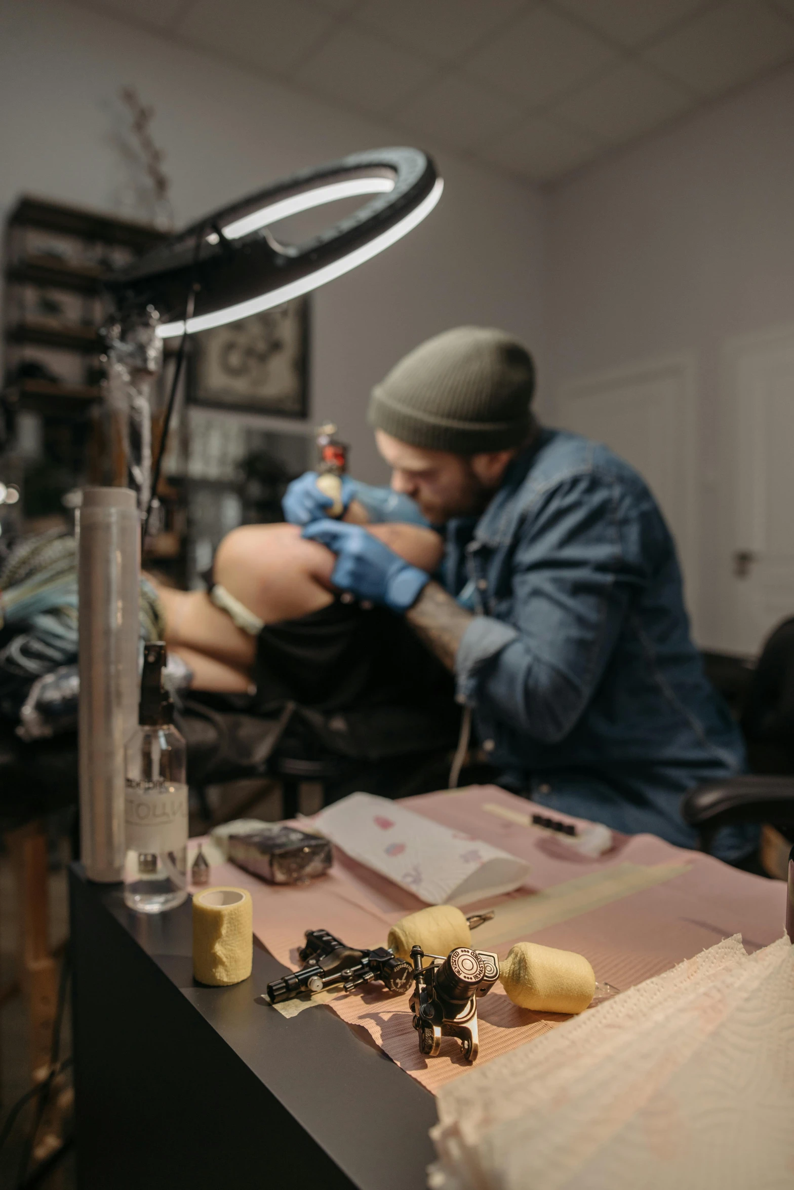 a man getting a tattoo at a tattoo parlor, by Ben Zoeller, trending on pexels, sitting on a lab table, stitching, adafruit, thigh skin