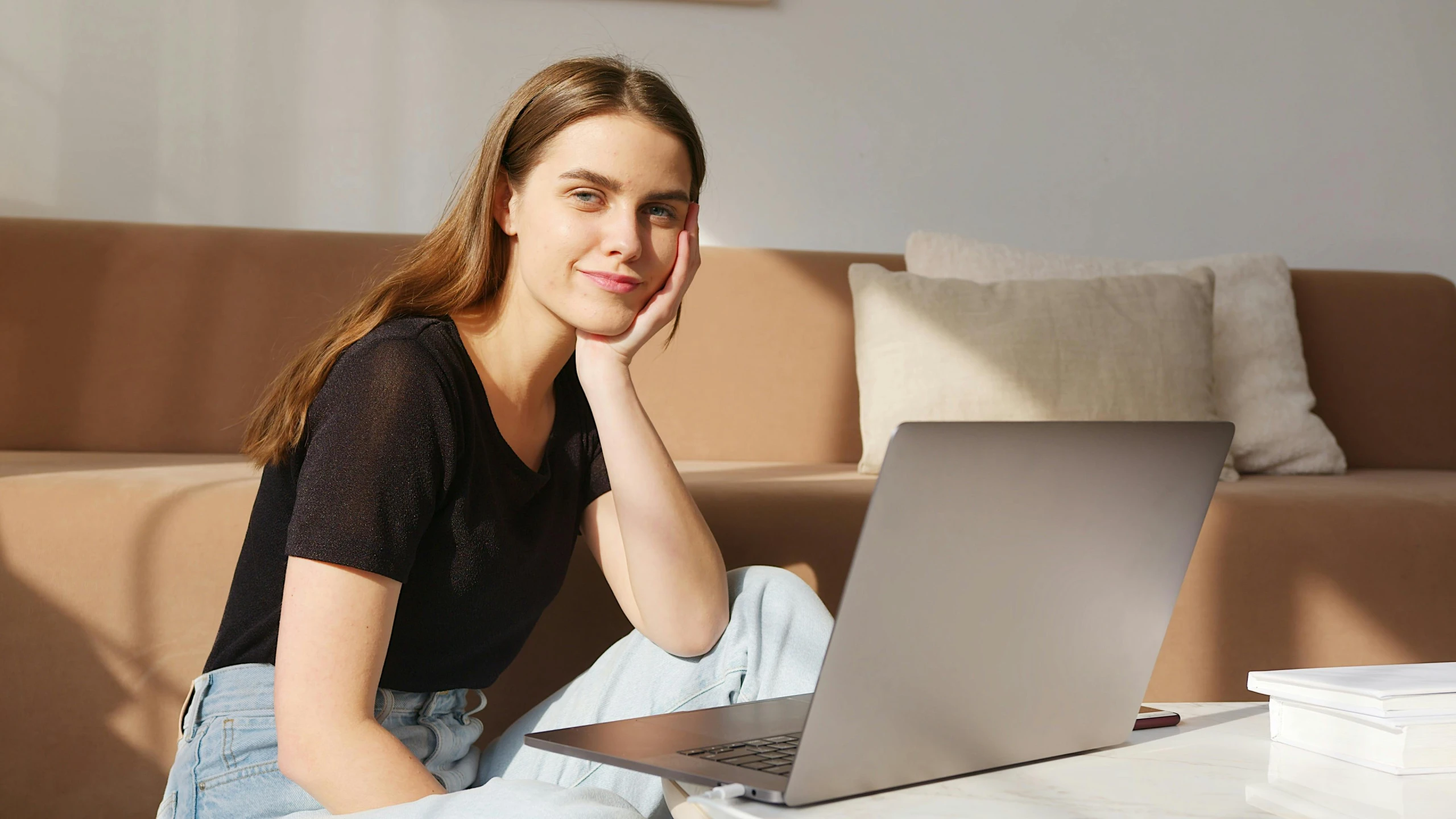 a woman sitting in front of a laptop computer, a portrait, by Carey Morris, trending on pexels, happening, someone sits in bed, chilled out smirk on face, handsome girl, product introduction photo