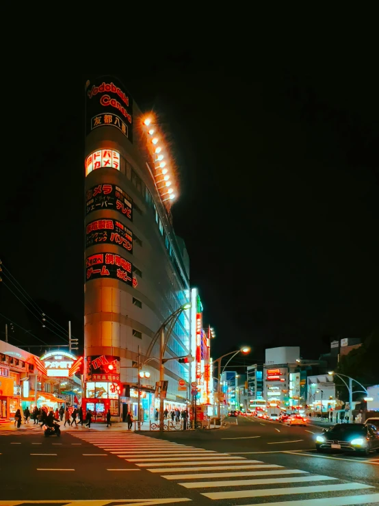 a city street filled with lots of traffic at night, colorful building, koji morimoto shinjuku, instagram story, wide angle exterior 2022