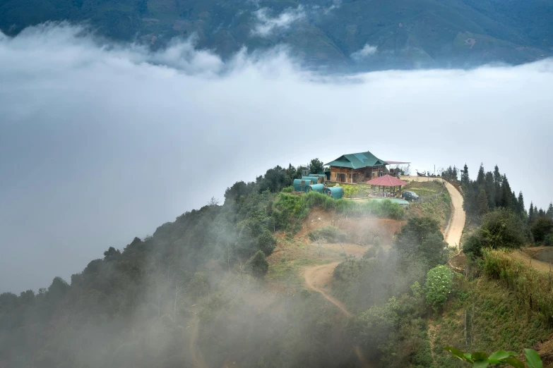 a house sitting on top of a lush green hillside, an album cover, pexels contest winner, sumatraism, layered fog, vietnam, panoramic, 2 5 6 x 2 5 6 pixels