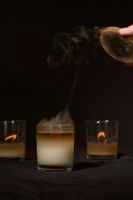 a person is sprinkling a candle in a glass, inspired by Jan Rustem, purism, gunpowder smoke, smoked layered, ignant, nightcap