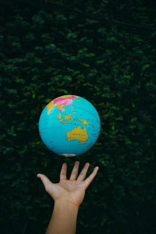 a person holding a blue and green globe in their hand, pexels contest winner, instagram post, 1 2 9 7, sydney hanson, 15081959 21121991 01012000 4k