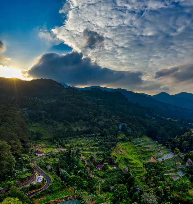 the sun is setting over a valley in the mountains, by Sebastian Spreng, pexels contest winner, sumatraism, kerala village, wide angle shot 4 k hdr, bird\'s eye view, lush farm lands