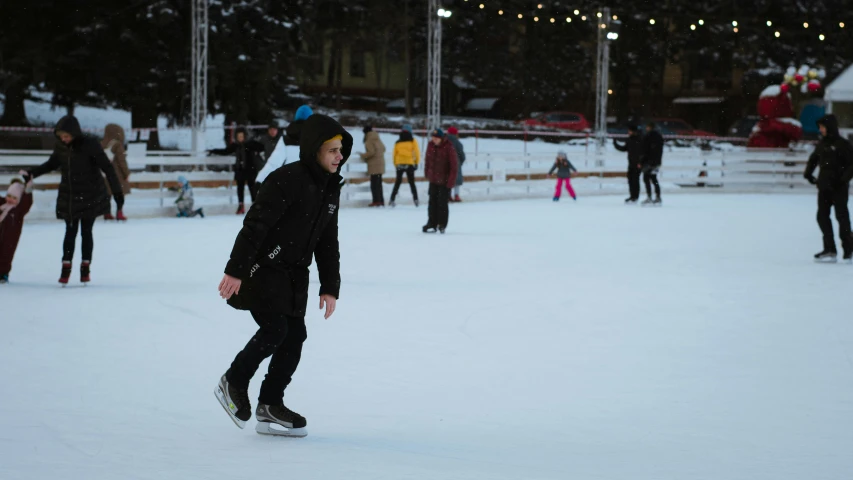 a man riding a snowboard down a snow covered slope, at a skate park, people walking around, minna sundberg, people enjoying the show