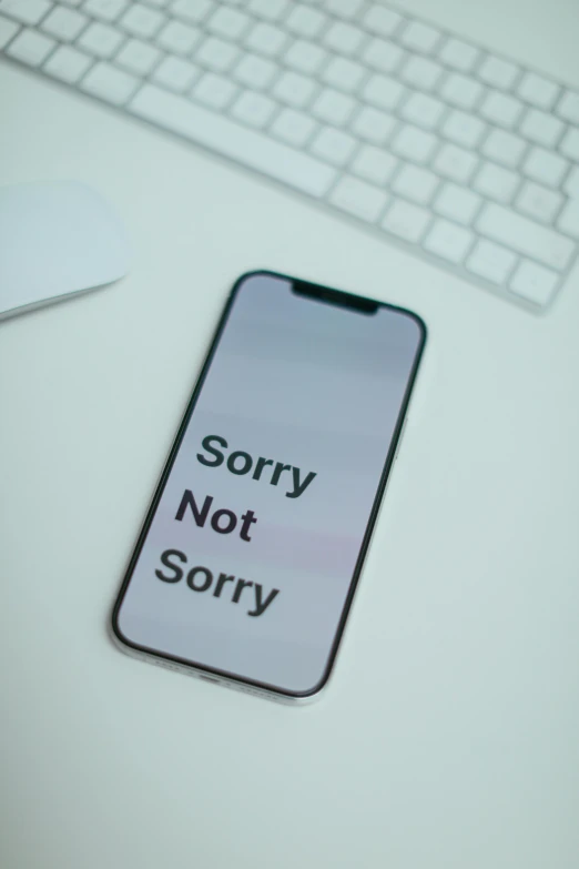 a cell phone sitting on top of a desk next to a keyboard, a picture, forgiveness, thumbnail, not cropped, profile image