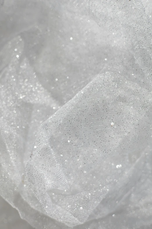 a pile of ice sitting on top of a table, flowing shimmering fabrics, white: 0.5, detailed product image, glittery wedding