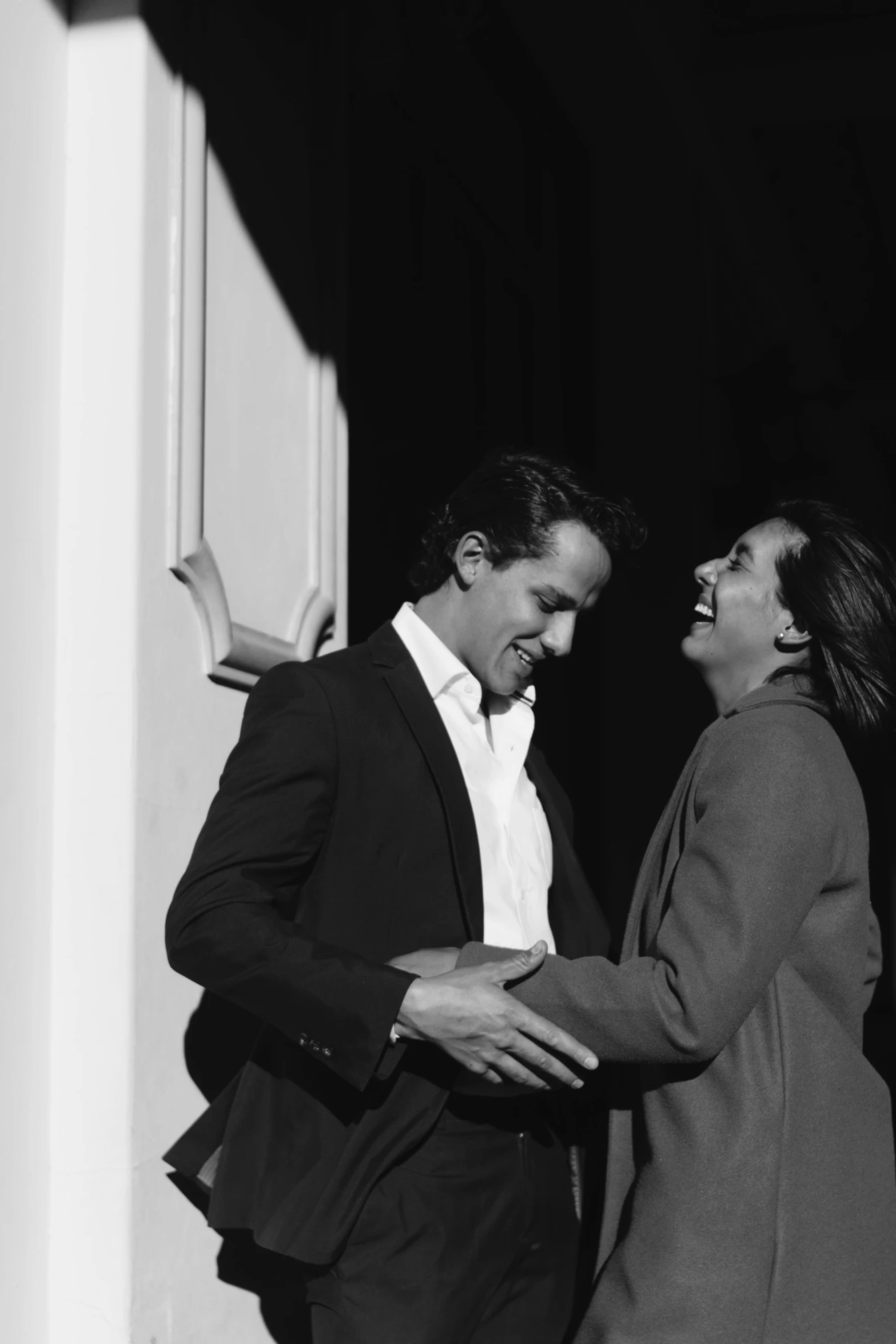 a black and white photo of a man and a woman, a black and white photo, by Caro Niederer, romanticism, hugh grant, giggling, john picacio and brom, alessandro bavari