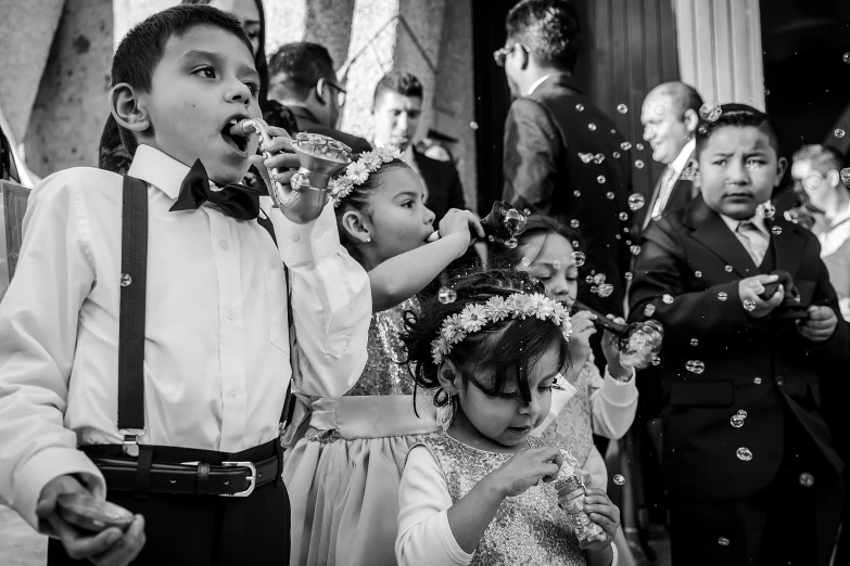 a black and white photo of children blowing bubbles, a black and white photo, by Lucia Peka, pexels contest winner, glittery wedding, kerem beyit, baptism, very detailed!!