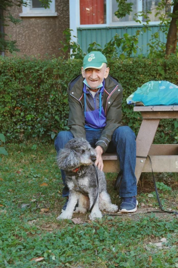 a man sitting on a bench next to a dog, grandfatherly, profile image, rené laloux, a green