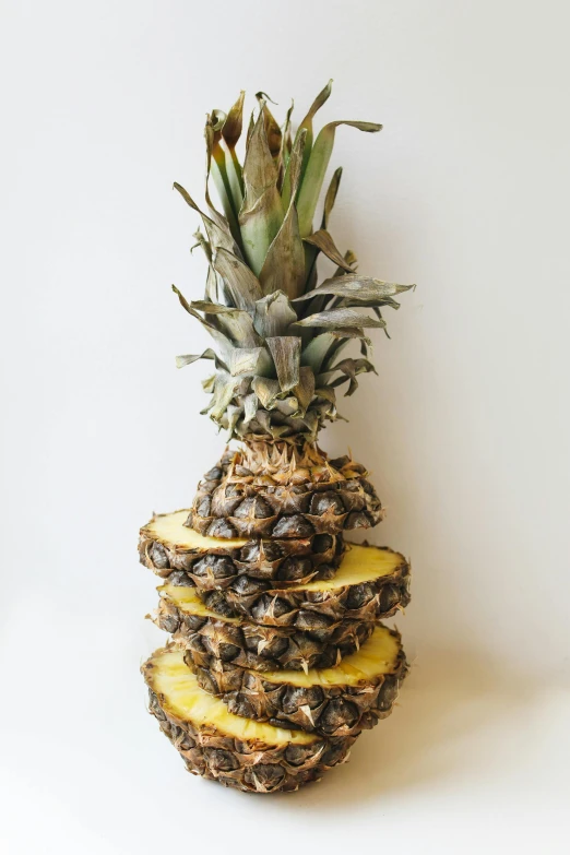 a pineapple sitting on top of a white table, multiple layers, crispy, the flower tower, 6 pack