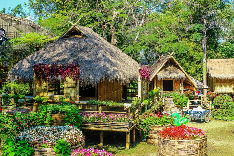 a garden filled with lots of different types of flowers, bamboo huts, in style of thawan duchanee, on a sunny day, exterior