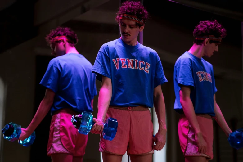 a group of young men standing next to each other, by Jacob Toorenvliet, unsplash, renaissance, 3 actors on stage, dayglo pink and blue, carrying two barbells, venice biennale