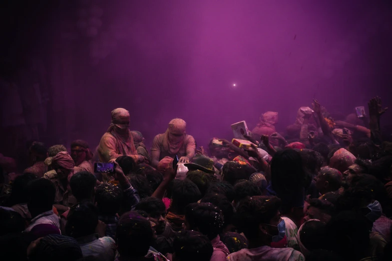 a group of people standing on top of a stage, pexels contest winner, bengal school of art, color pigments spread out in air, purple - tinted, crowds of people praying, 15081959 21121991 01012000 4k