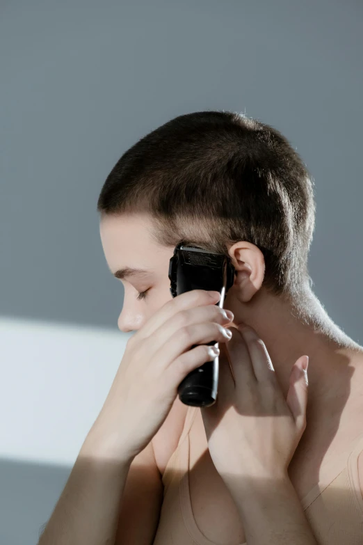 a shirtless man holding a cell phone to his ear, by artist, trending on pexels, hypermodernism, buzz cut hair, hairdryer, ryoji, square masculine jaw