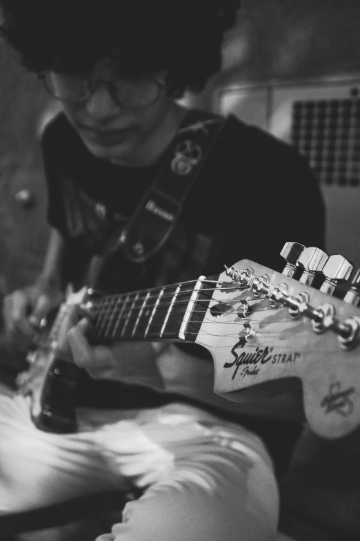 a black and white photo of a person playing a guitar, by Felix-Kelly, roleplay, steve zheng, fender stratocaster, uploaded