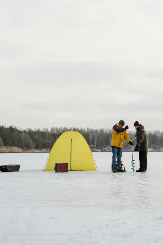 a couple of people standing on top of a snow covered field, fishing, tent, espoo, yellow