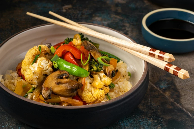 a close up of a bowl of food with chopsticks, confident holding vegetables, square, background image, professional food photography