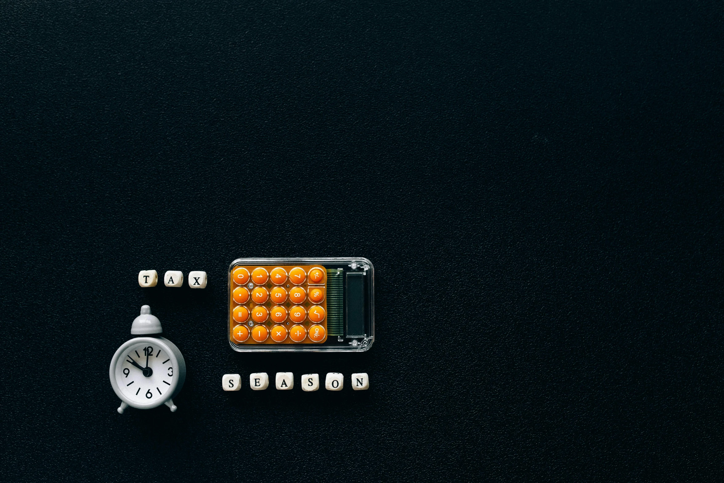 an alarm clock sitting on top of a black table, pills, tetris, black and orange, thumbnail