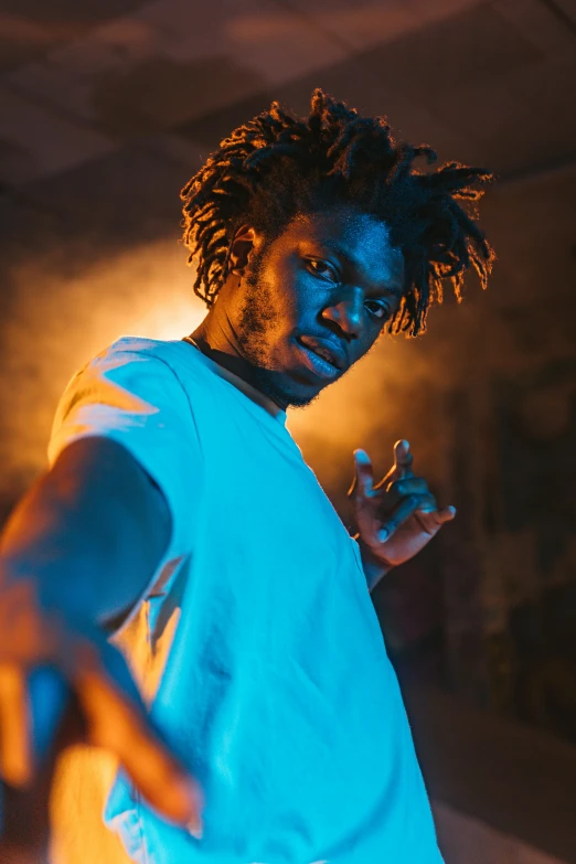 a man with dreadlocks standing in a dark room, trending on pexels, hero pose colorful city lighting, ( ( dark skin ) ), rapper, looking threatening