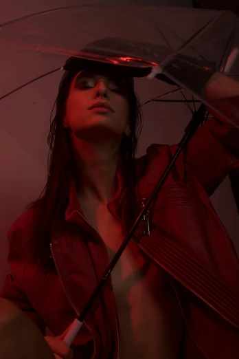 a woman in a red jacket holding an umbrella, an album cover, inspired by Elsa Bleda, trending on pexels, photorealism, in a leather corset, portrait emily ratajkowski, darkness aura red light, showstudio