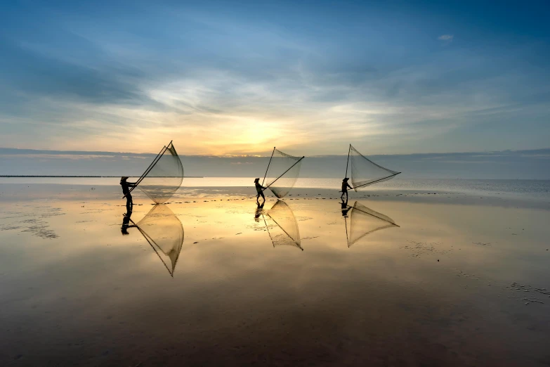 a group of people standing on top of a sandy beach, inspired by Steve McCurry, pexels contest winner, minimalism, fishing, nets, mirror reflection, omaha beach