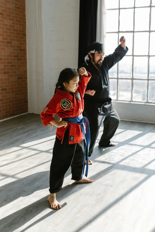 a couple of people that are standing in a room, inspired by Liao Chi-chun, fist training, kids, black, performance