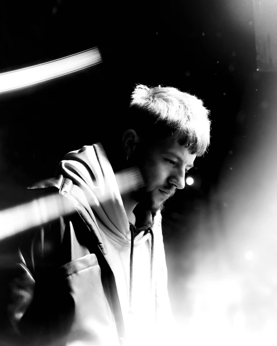 a black and white photo of a man with a baseball bat, by Adam Marczyński, unsplash, hurufiyya, with lots of glittering light, he looks like tye sheridan, facing to audience, demna gvasalia