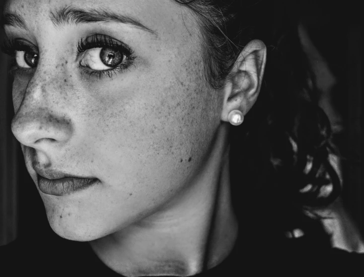 a black and white photo of a woman with freckles, by Matthias Weischer, pexels, girl with a pearl earringl, icon black and white, teenage girl, realistic person