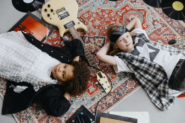 a couple of kids laying on top of a rug, an album cover, trending on pexels, electric guitars, bandanas, 15081959 21121991 01012000 4k, henri moore