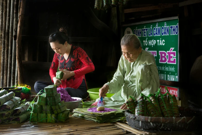 a couple of women sitting next to each other at a table, by Dan Content, bamboo huts, portrait image, bao phan, preparing to fight