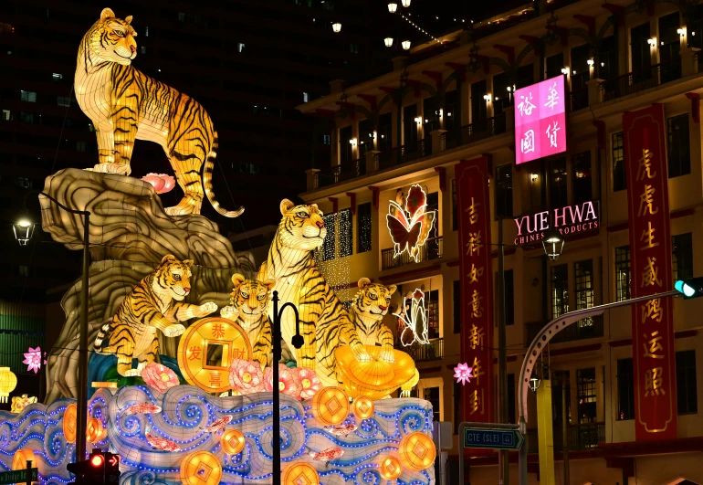 a group of tigers sitting on top of a float, a digital rendering, by Julia Pishtar, pexels contest winner, hurufiyya, china town, warm street lights store front, singapore esplanade, taken in the late 2010s