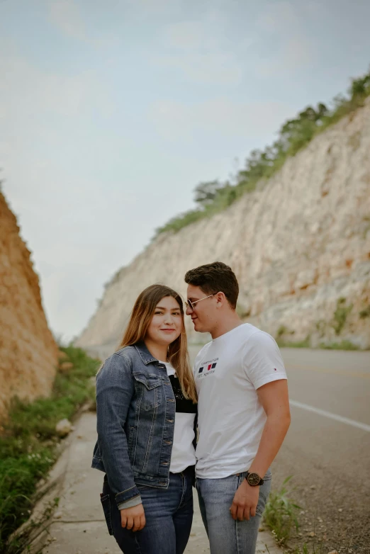 a couple standing next to each other on the side of a road, profile image