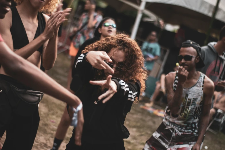 a group of people standing on top of a grass covered field, pexels contest winner, graffiti, other women dancing behind, amen beats jungle party, curly afro, bella poarch