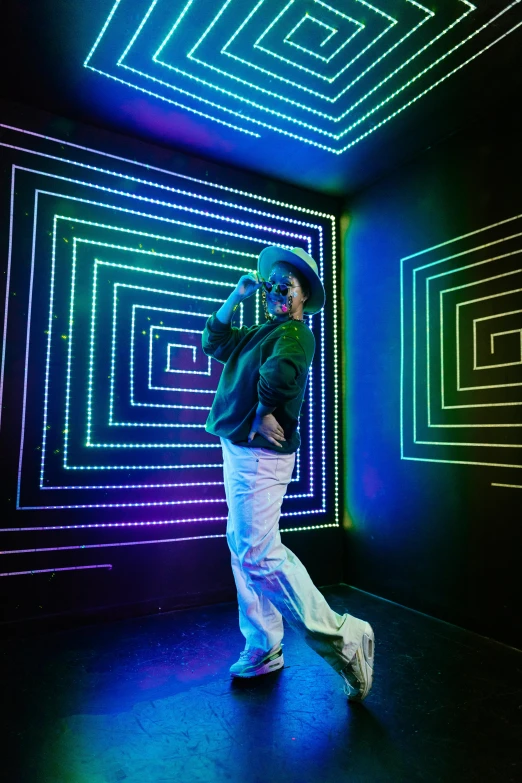 a man that is standing in a room with neon lights, maze-like, doing a sassy pose, afro tech, standing in corner of room