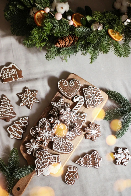 a wooden cutting board topped with cookies on top of a table, by Julia Pishtar, folk art, sparkling light, thumbnail, nordic, caramel