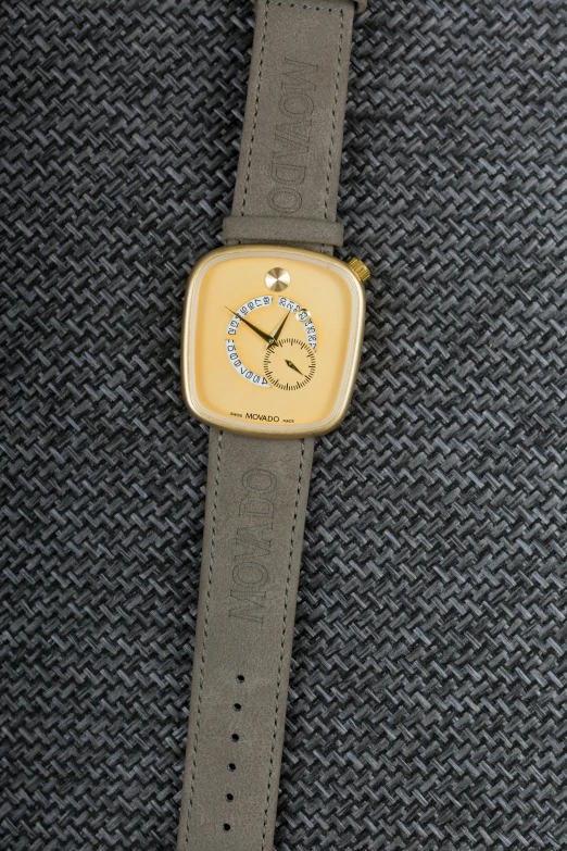 a close up of a watch on a cloth, inspired by Pedro Pedraja, reddit, mono-yellow, square, 4 k product photo, taupe