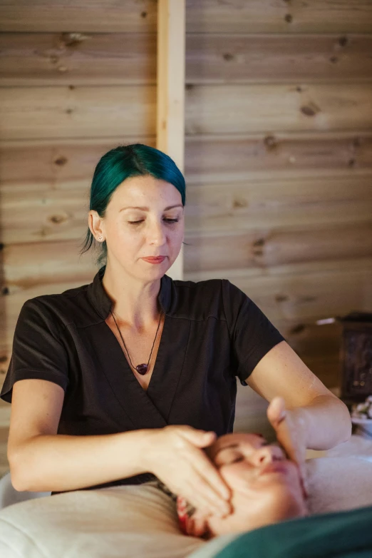 a woman sitting on top of a bed next to a baby, a portrait, unsplash, renaissance, bone jewellery, in a workshop, tara mcpherson, seated at a table