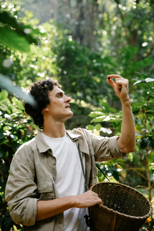 a man standing in a forest holding a basket, chocolate, fascinated, australian, in a jungle