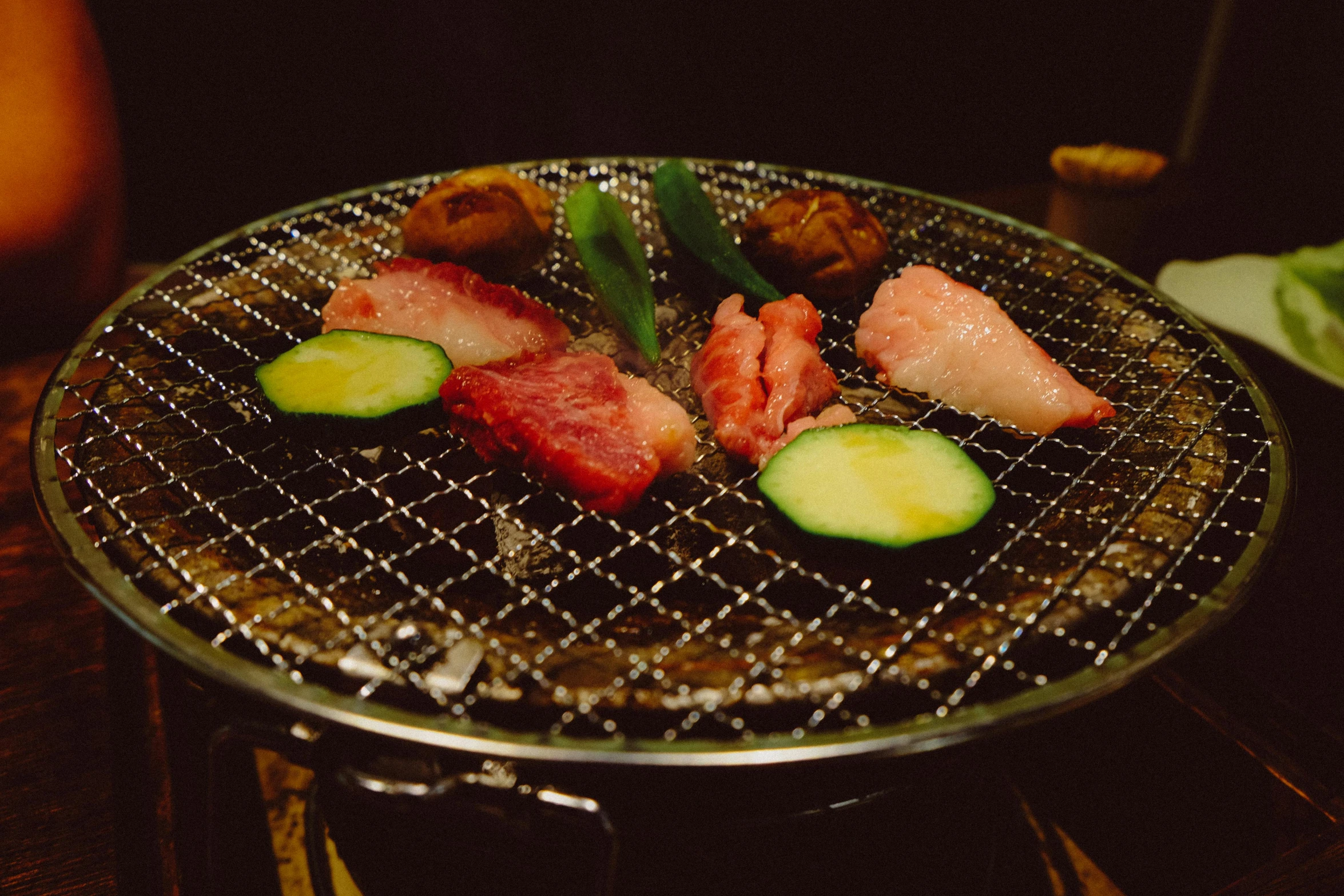 a close up of a grill with meat and vegetables on it, inspired by Miyagawa Chōshun, unsplash, mingei, grey, nighttime, round, “ full body