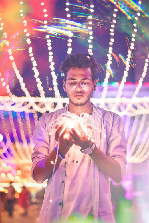 a man holding a crystal ball in his hands, a hologram, by Julia Pishtar, pexels contest winner, avan jogia angel, party lights, looking happy, aura jared and wires