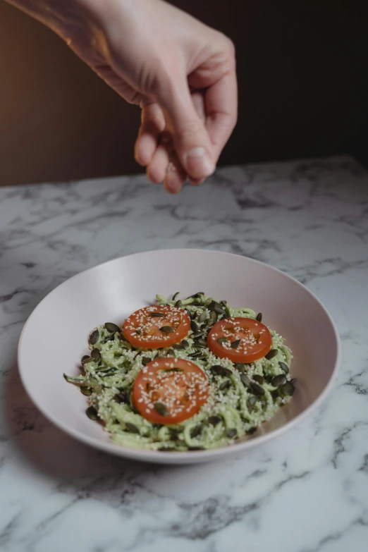 a close up of a plate of food on a table, inspired by Lucia Peka, green wavy hair, sleek hands, noodles, also tomato